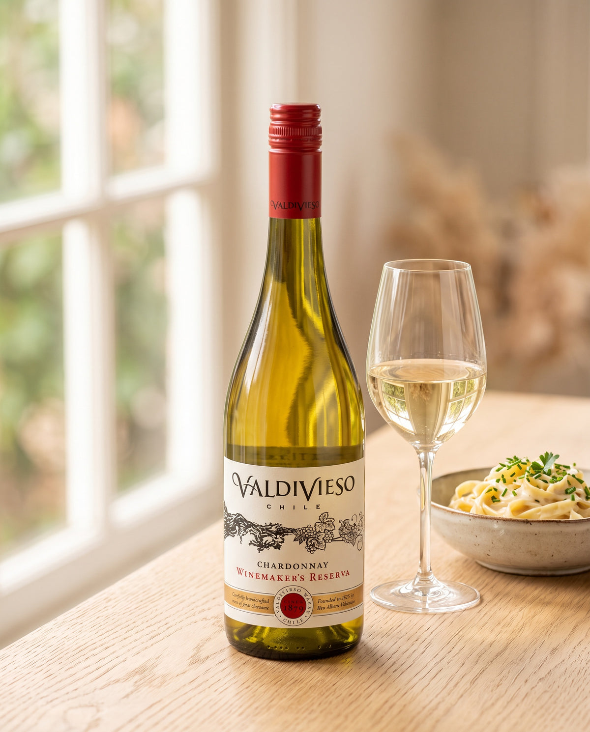 Valdivieso Winemaker's Reserve Chardonnay by a kitchen window with creamy pasta